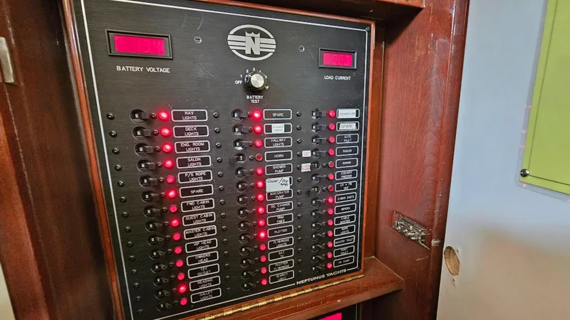 Dream Team Xiii Yacht Photos Pics Electrical panel of 2005 Neptunus 56 Flybridge yacht with illuminated switches and indicators.