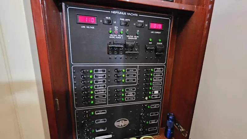 Dream Team Xiii Yacht Photos Pics Electrical panel of 2005 Neptunus 56 Flybridge yacht, showing voltage and current displays.