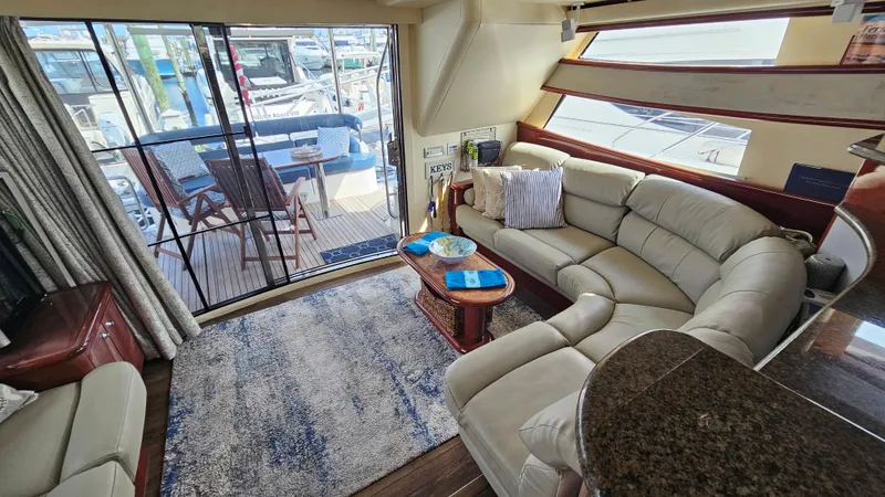 Dream Team Xiii Yacht Photos Pics Luxurious interior of 2005 Neptunus 56 Flybridge yacht with plush seating and elegant decor.