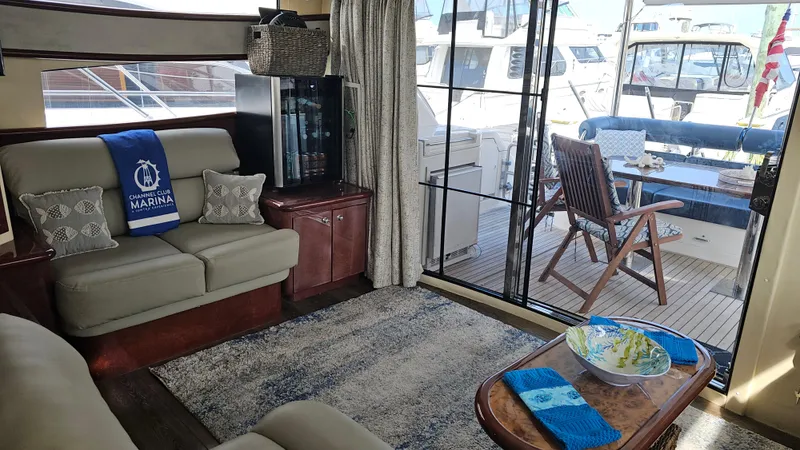 Dream Team Xiii Yacht Photos Pics Luxurious 2005 Neptunus 56 Flybridge yacht interior with cozy seating and marina view.