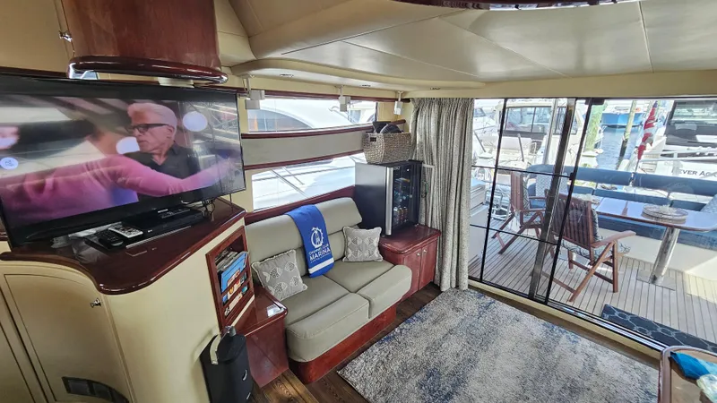 Dream Team Xiii Yacht Photos Pics Luxurious interior of 2005 Neptunus 56 Flybridge yacht with cozy seating and entertainment area.