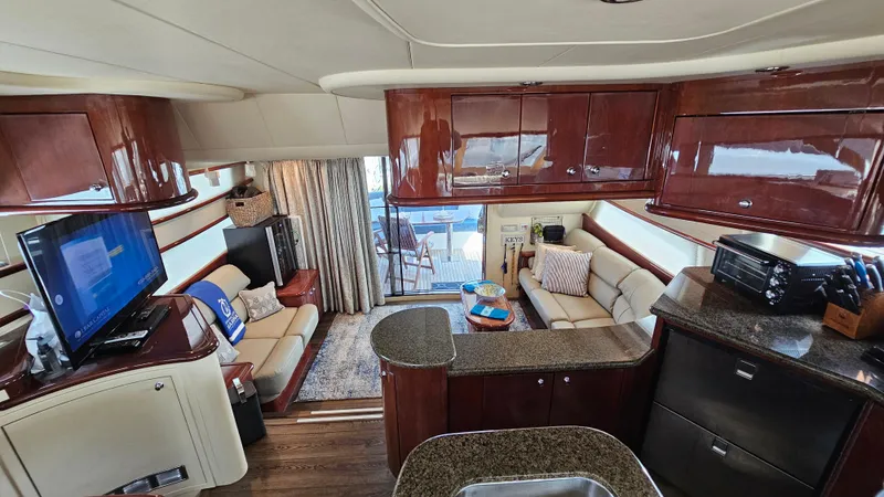 Dream Team Xiii Yacht Photos Pics Luxurious interior of 2005 Neptunus 56 Flybridge yacht with elegant wood finishes.