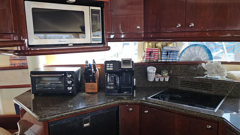 Dream Team Xiii Yacht Photos Pics Modern kitchen in 2005 Neptunus 56 Flybridge yacht with appliances and granite countertops.