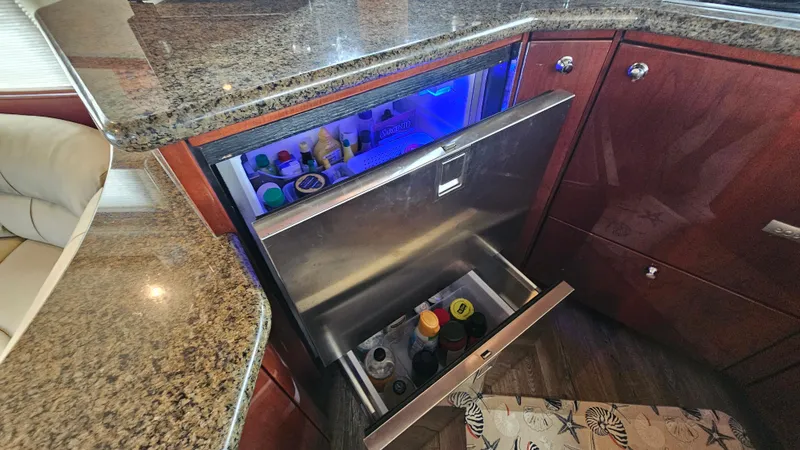 Dream Team Xiii Yacht Photos Pics Luxury yacht Neptunus 56 Flybridge 2005 with open refrigerator and granite countertop.