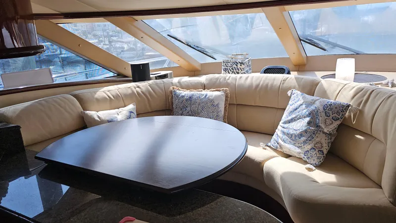 Dream Team Xiii Yacht Photos Pics Luxurious interior of 2005 Neptunus 56 Flybridge yacht with plush seating and elegant decor.