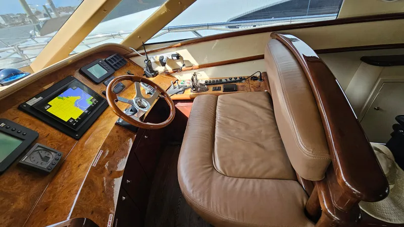 Dream Team Xiii Yacht Photos Pics Luxurious 2005 Neptunus 56 Flybridge yacht helm with leather seating and navigation equipment.