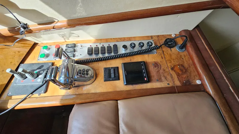 Dream Team Xiii Yacht Photos Pics Control panel of a 2005 Neptunus 56 Flybridge yacht with various switches and levers.