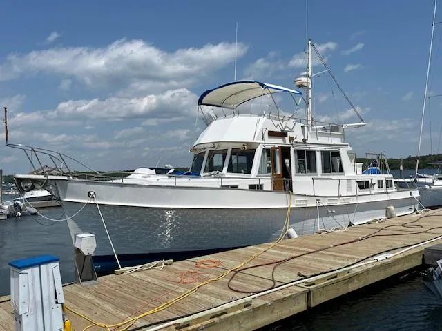 Slow Poke Yacht Photos Pics 1987 Grand Banks Classic Trawler (Hull #20) docked at marina under blue sky.