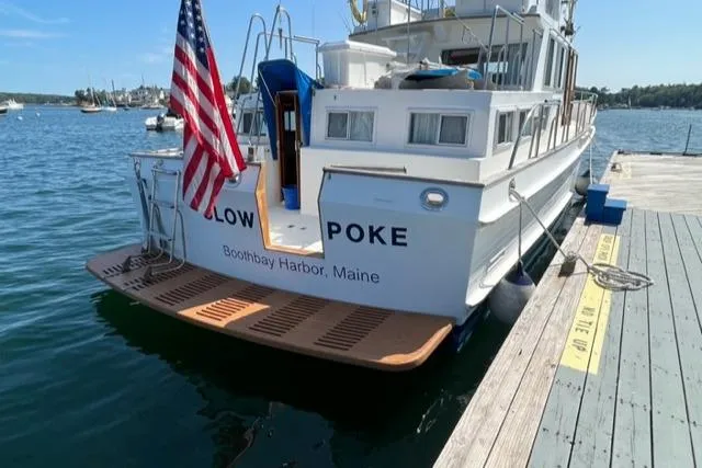 Slow Poke Yacht Photos Pics 1987 Grand Banks Classic Trawler docked at Boothbay Harbor, Maine, with American flag.