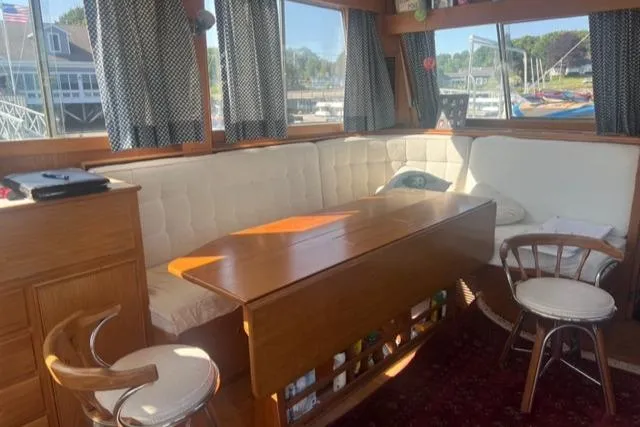 Slow Poke Yacht Photos Pics Interior of 1987 Grand Banks Classic Trawler with cozy seating and wooden table.