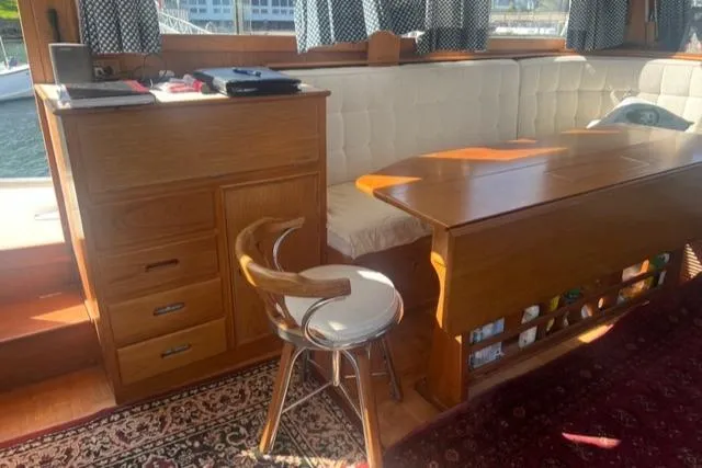 Slow Poke Yacht Photos Pics Interior of 1987 Grand Banks Classic Trawler with wooden furniture and seating area.