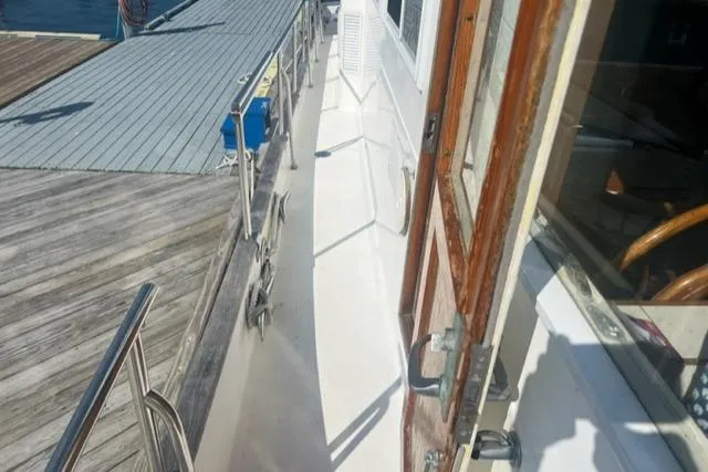 Slow Poke Yacht Photos Pics 1987 Grand Banks Classic Trawler (Hull #20) docked, showing side deck and wooden door.