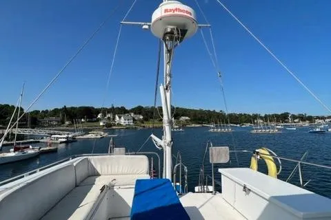Slow Poke Yacht Photos Pics 1987 Grand Banks Classic Trawler on water, featuring spacious deck and scenic harbor view.