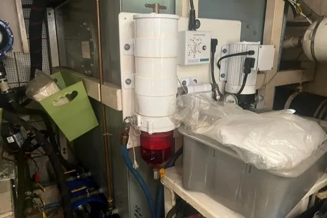 Slow Poke Yacht Photos Pics Engine room of 1987 Grand Banks Classic Trawler, featuring equipment and storage containers.