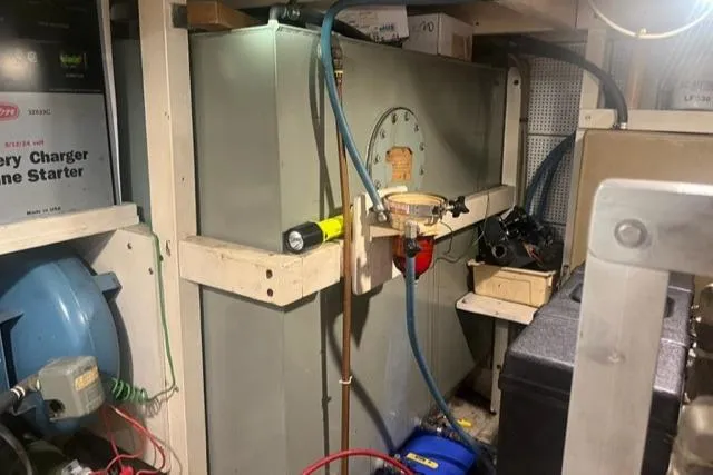 Slow Poke Yacht Photos Pics Engine room of 1987 Grand Banks Classic Trawler, featuring equipment and storage.