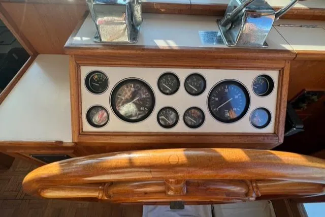 Slow Poke Yacht Photos Pics 1987 Grand Banks Classic Trawler helm with gauges and wooden steering wheel.