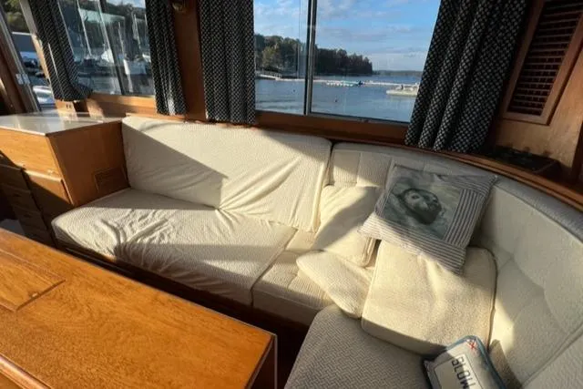 Slow Poke Yacht Photos Pics Interior of 1987 Grand Banks Classic Trawler with cozy seating and scenic window view.