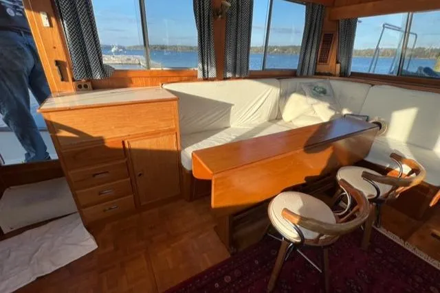 Slow Poke Yacht Photos Pics Interior of 1987 Grand Banks Classic Trawler with wooden furniture and waterfront view.