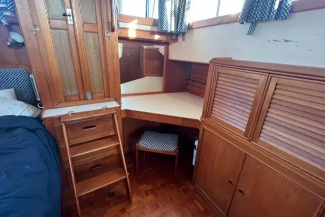 Slow Poke Yacht Photos Pics 1987 Grand Banks Classic Trawler interior with wooden cabinetry and cozy seating area.