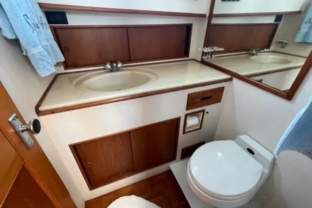 Slow Poke Yacht Photos Pics 1987 Grand Banks Classic Trawler bathroom with sink, mirror, and toilet.