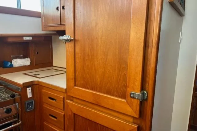 Slow Poke Yacht Photos Pics 1987 Grand Banks Classic Trawler kitchen with wooden cabinetry and stove.