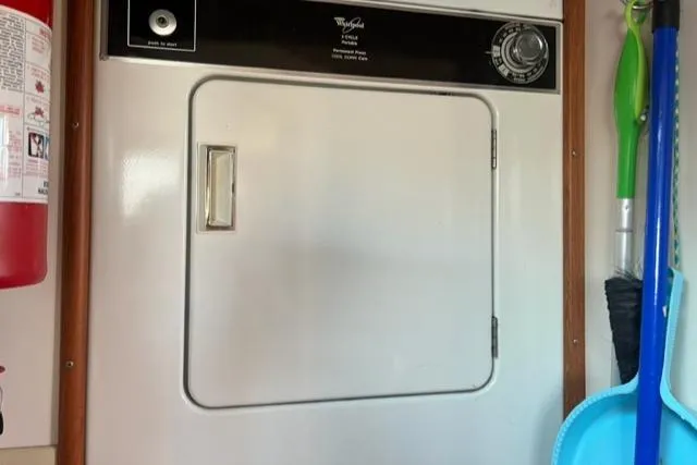 Slow Poke Yacht Photos Pics Laundry area with Whirlpool dryer on 1987 Grand Banks Classic Trawler.