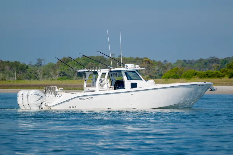  Yacht Photos Pics 2022 Solace 41 CS boat cruising on calm water with fishing rods.