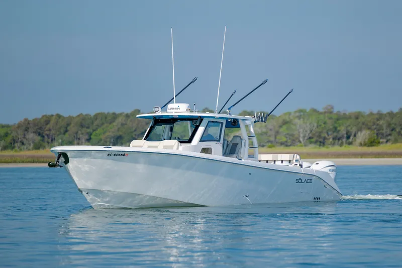  Yacht Photos Pics 2022 Solace 41 CS boat cruising on calm water with fishing rods.