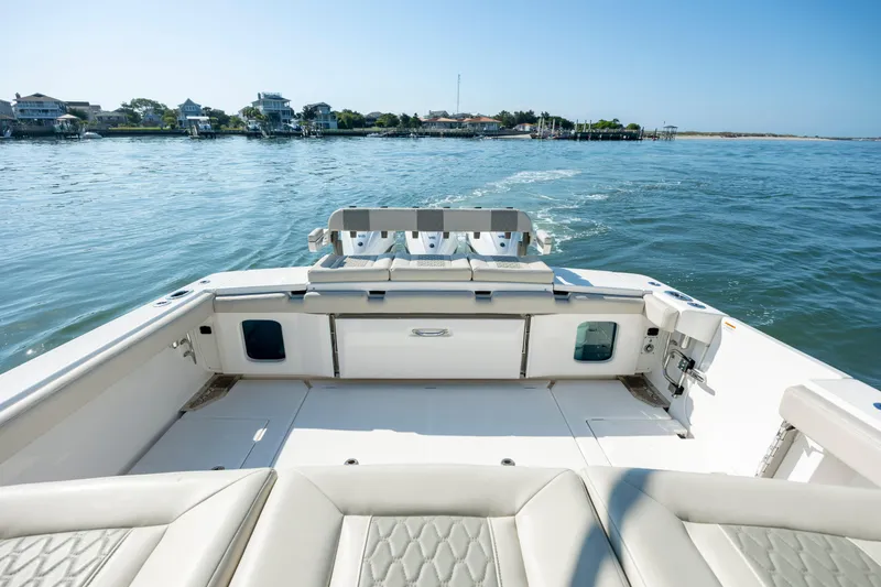  Yacht Photos Pics 2022 Solace 41 CS boat on calm water, featuring spacious deck and seating.