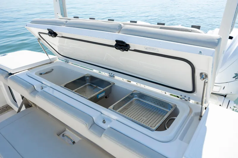  Yacht Photos Pics Open storage compartment on 2022 Solace 41 CS boat with trays, near water.