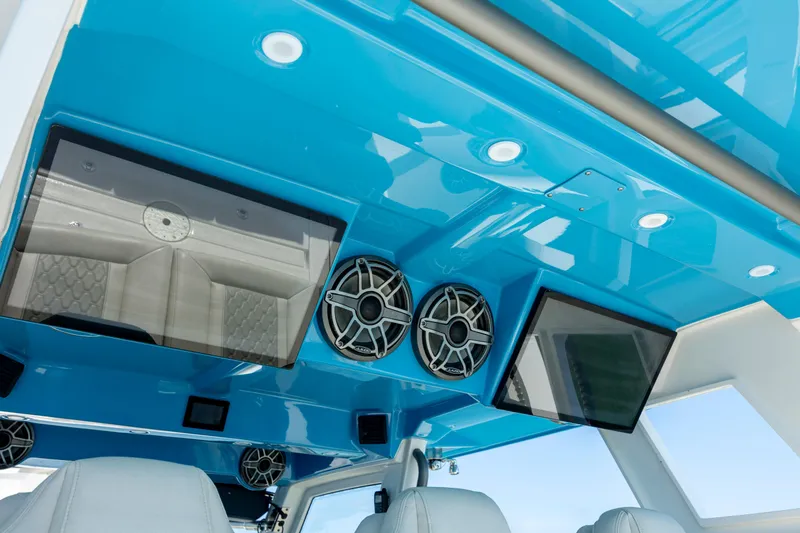  Yacht Photos Pics Interior view of 2022 Solace 41 CS boat, featuring blue ceiling with speakers and screens.