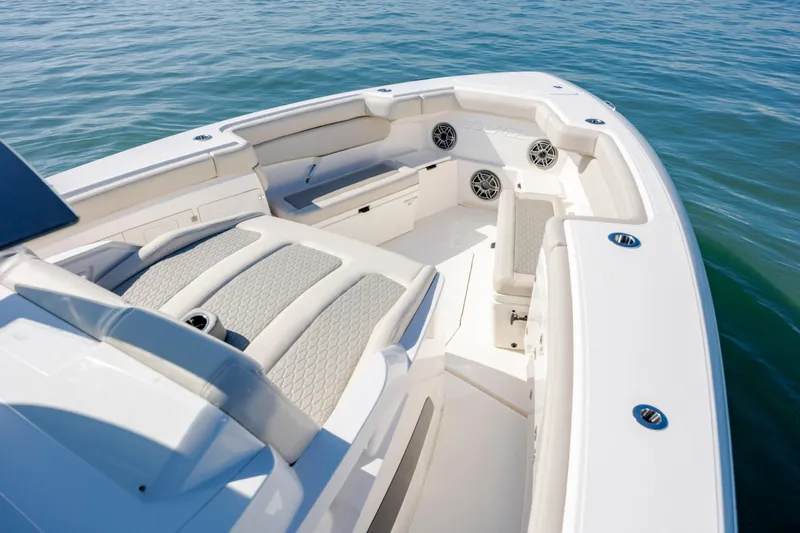  Yacht Photos Pics 2022 Solace 41 CS boat interior with cushioned seating and speakers on calm water.