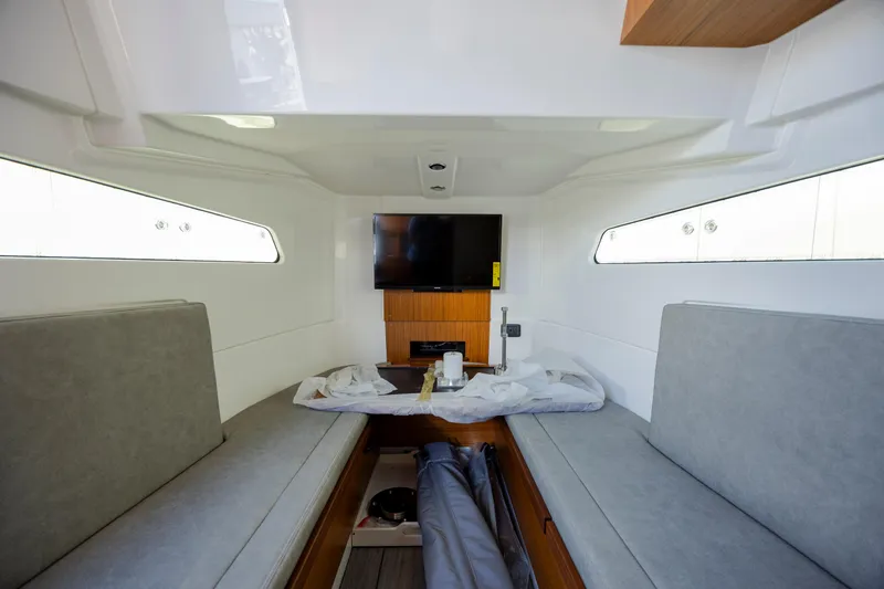  Yacht Photos Pics Cozy interior cabin of 2022 Solace 41 CS boat with seating and TV.
