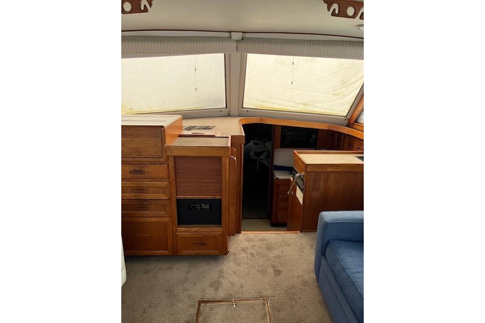 Interior of 1979 Pacemaker 40 Sportfisher with wooden cabinetry and carpeted flooring.