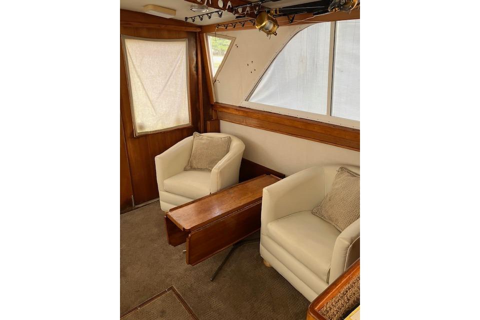 Interior of 1979 Pacemaker 40 Sportfisher with cozy seating and wooden accents.