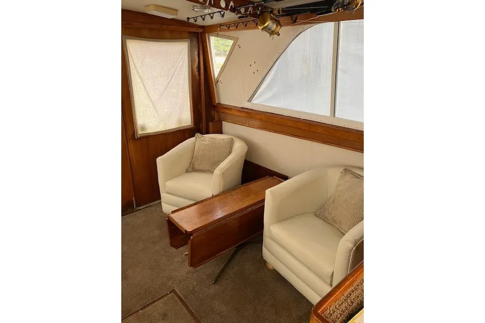 Interior of 1979 Pacemaker 40 Sportfisher with cozy seating and wooden accents.