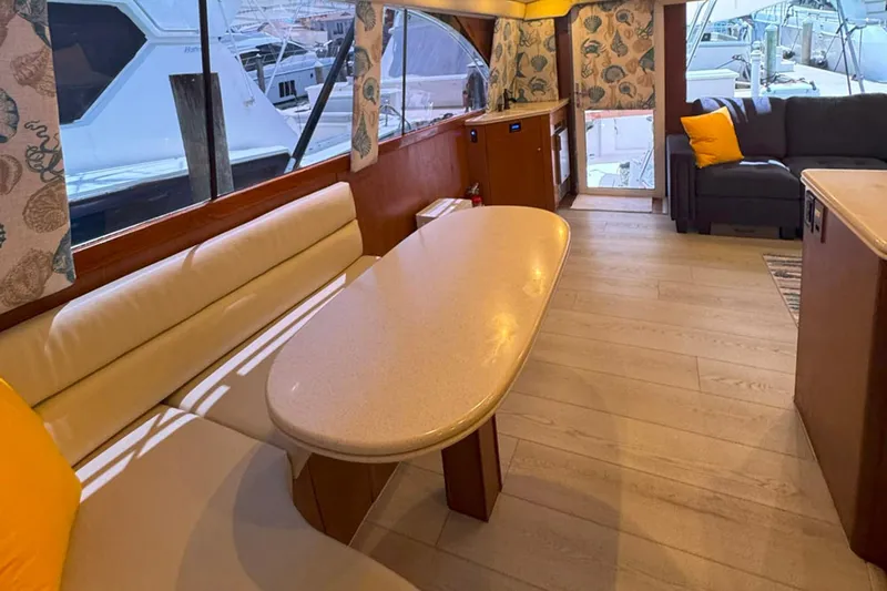 Happy Our's Yacht Photos Pics Luxurious interior of a 1997 Ocean Yachts 48 Super Sport with elegant seating and decor.