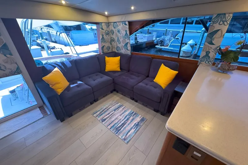 Happy Our's Yacht Photos Pics Luxurious interior of 1997 Ocean Yachts 48 Super Sport with cozy seating and vibrant decor.