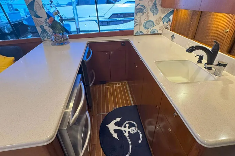 Happy Our's Yacht Photos Pics 1997 Ocean Yachts 48 Super Sport kitchen with modern appliances and nautical decor.