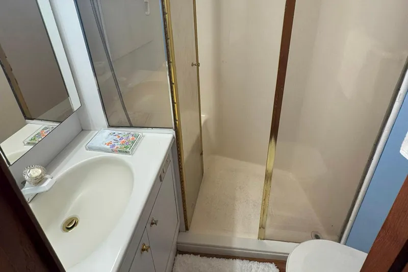 Happy Our's Yacht Photos Pics Bathroom interior of 1997 Ocean Yachts 48 Super Sport with shower and sink.