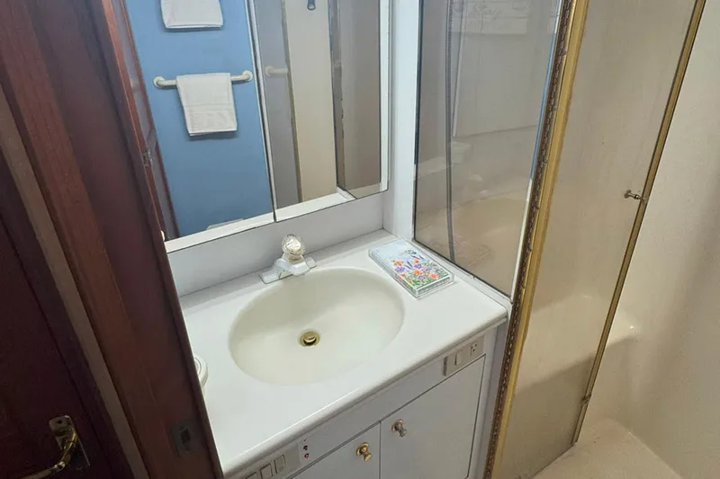Happy Our's Yacht Photos Pics Bathroom vanity in 1997 Ocean Yachts 48 Super Sport, featuring sink and mirror.