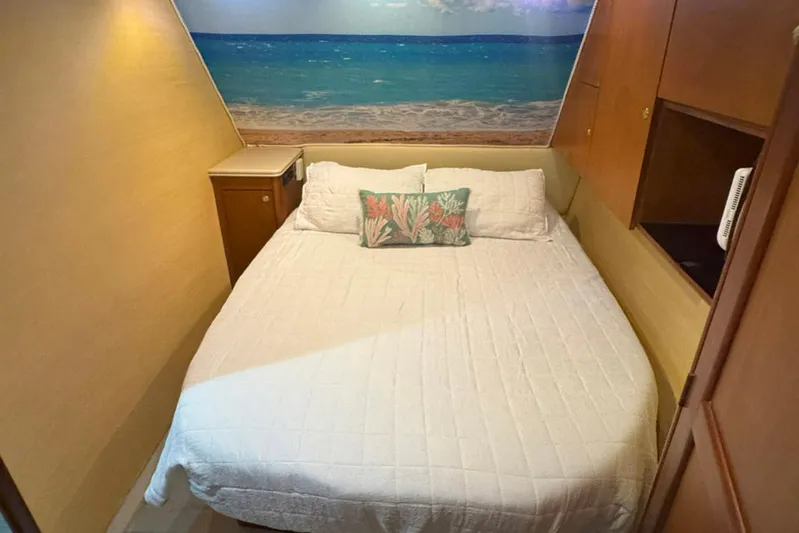 Happy Our's Yacht Photos Pics Cozy bedroom in 1997 Ocean Yachts 48 Super Sport with beach-themed decor.