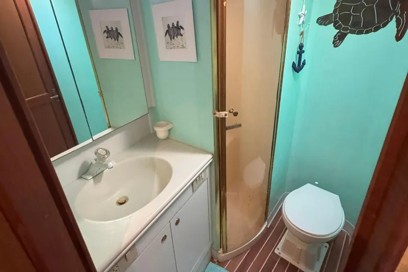 Happy Our's Yacht Photos Pics Bathroom of 1997 Ocean Yachts 48 Super Sport with shower, sink, and toilet.