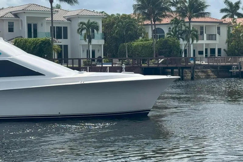 Happy Our's Yacht Photos Pics 1997 Ocean Yachts 48 Super Sport yacht near waterfront homes and palm trees.