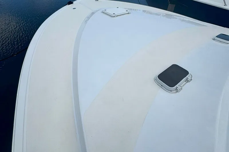 Happy Our's Yacht Photos Pics 1997 Ocean Yachts 48 Super Sport boat deck with hatches, on calm water.