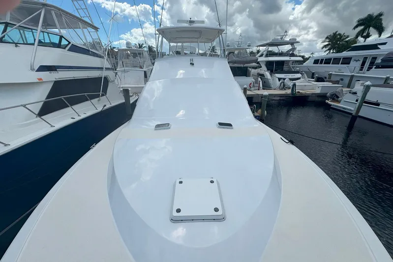 Happy Our's Yacht Photos Pics 1997 Ocean Yachts 48 Super Sport docked at marina under cloudy sky.