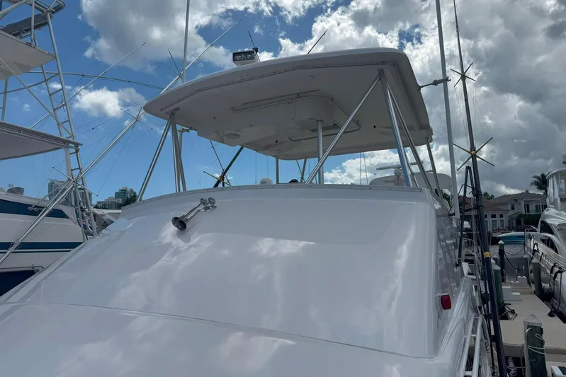 Happy Our's Yacht Photos Pics 1997 Ocean Yachts 48 Super Sport boat docked under cloudy sky.