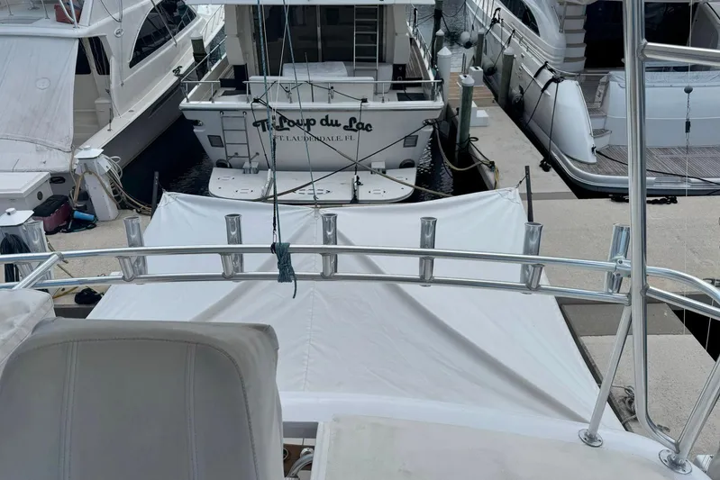 Happy Our's Yacht Photos Pics 1997 Ocean Yachts 48 Super Sport docked among other boats at a marina.