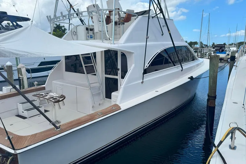 Happy Our's Yacht Photos Pics 1997 Ocean Yachts 48 Super Sport docked at marina under blue sky.