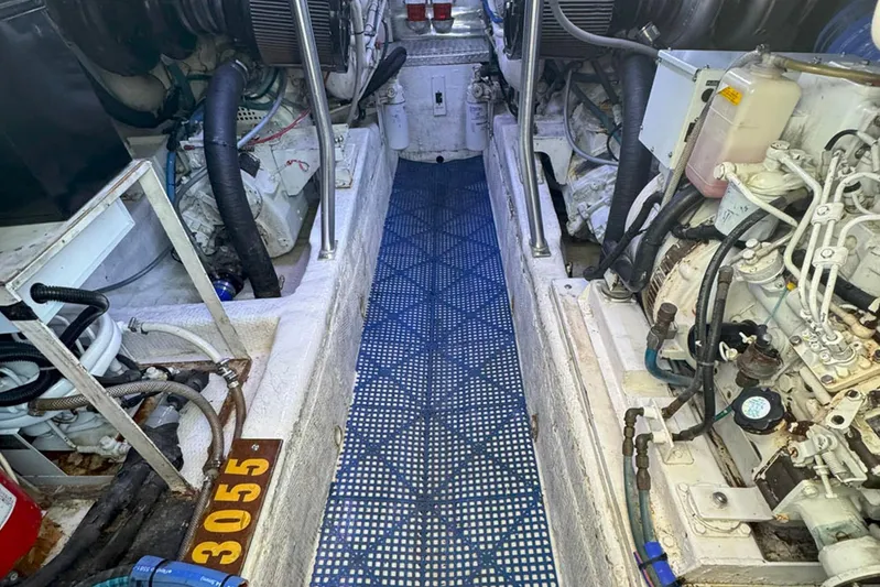 Happy Our's Yacht Photos Pics Engine room of a 1997 Ocean Yachts 48 Super Sport, showcasing mechanical components.